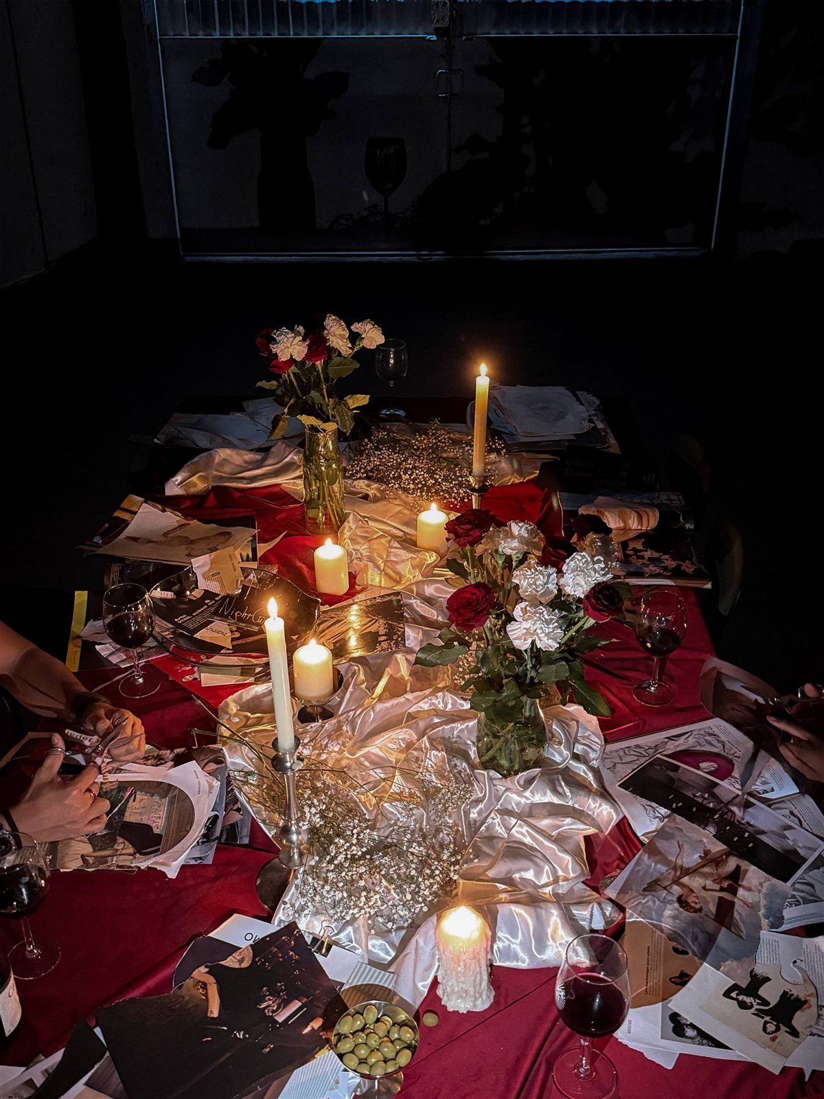 The NightCut table laid with magazines, paper and glasses.